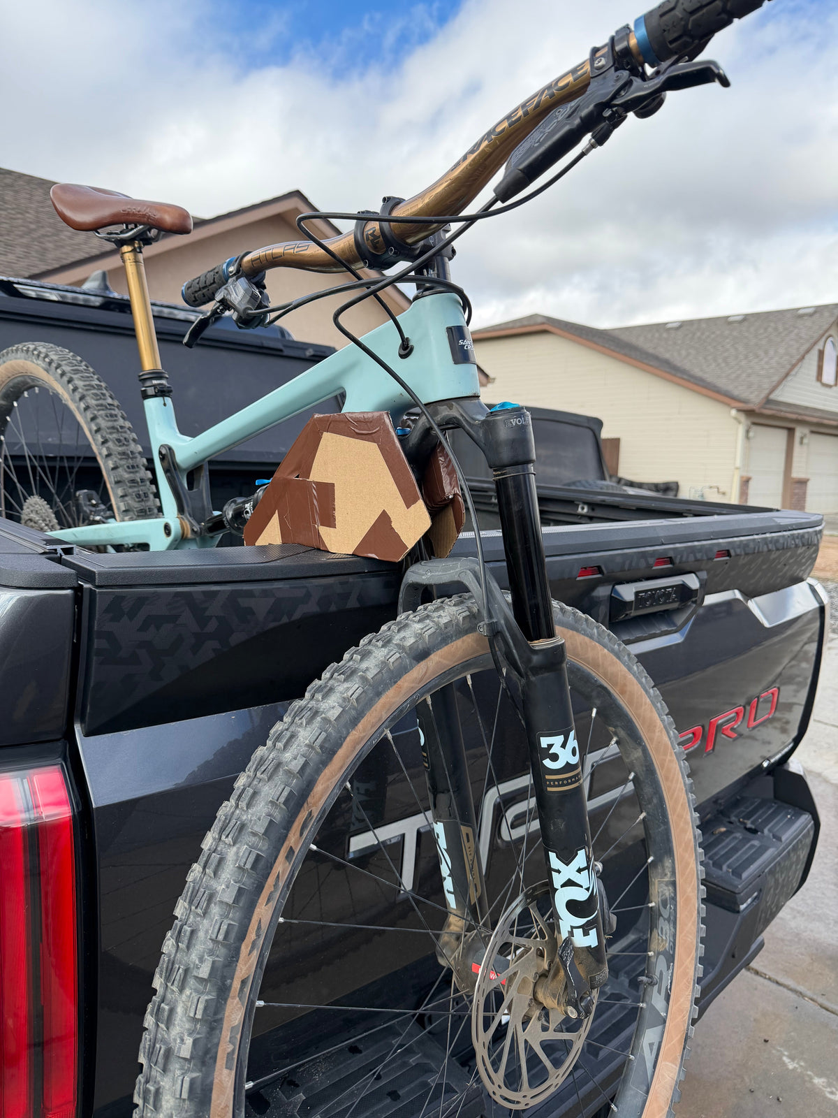 A mountain bike loaded onto a TerraGnar articulating rack on a Toyota Tundra TRD Pro tailgate